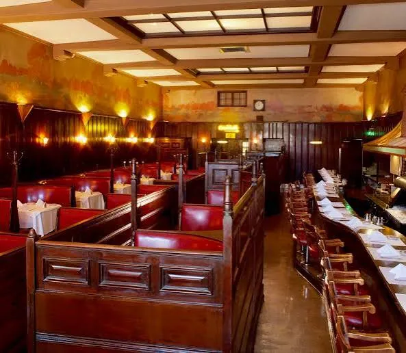 Red leather booths and dark wood paneling at Musso & Frank Grill