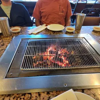 Hardwood charcoal grill pit at Soot Bull Jip
